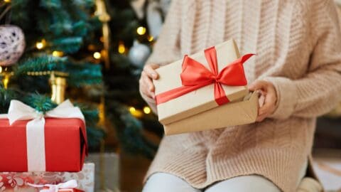Woman opening gift-box with xmas present